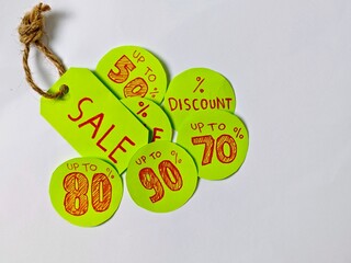 Vibrant Green Sale Tags with Red Discounts on White Background.