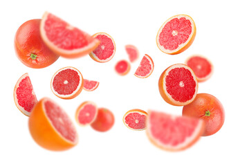Fresh grapefruits swirling in air against white background