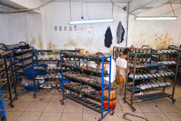 The shoemaker is making shoes in the workshop.

