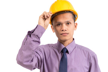 Close-up portrait of a handsome young man wearing a hard hat, an architect, looking at the camera on white background.