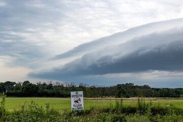 A shelf cloud and thunderstorm approaching a field of cover crops with a No Destructive Tillage...