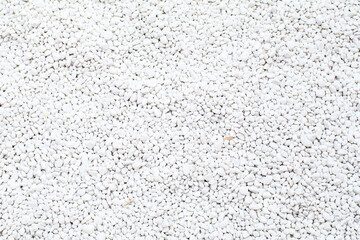 White decorative stones under morning light in garden. Decor or landscaping for aesthetic appeal. Texture. Background. Geometry.
 