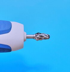  Metal cutter for pedicure. A close-up, side-profile shot of a silver carbide nail drill bit...
