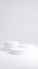 Three white circular podiums on a white background