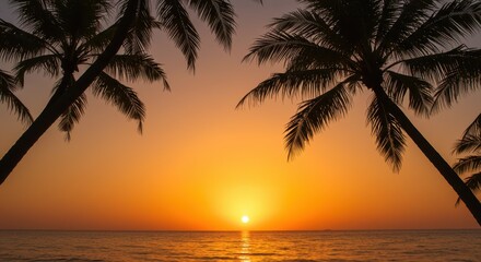 Obraz premium Tropical Sunset Paradise: Silhouetted Palm Trees Framing a Vibrant Orange Sky Over Calm Ocean Waters