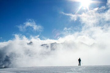 A skier on a snowy slope in the mountains of Andorra in winter.