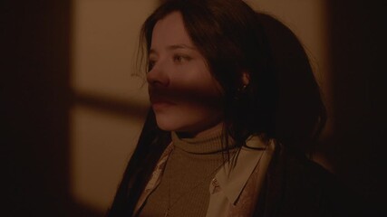 Artistic portrait of a young woman in shadow and light, creating a dramatic and film-inspired look. - Powered by Adobe