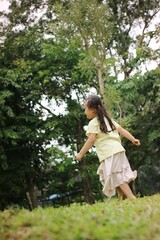 Young Girl Enjoying Time Outdoors in the Green Nature Park