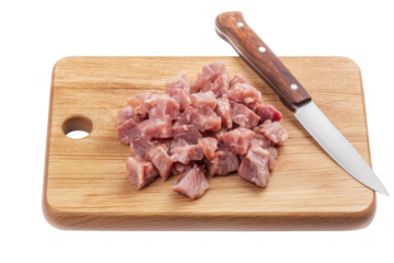 Wooden cutting board with diced raw pork and knife on transparent background