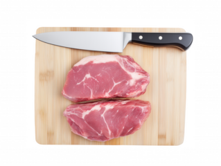 Two premium raw steaks with marbling on a wooden cutting board with a chef's knife isolated on transparent background