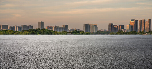 Serene Urban Landscape: Nature Meets City Skyline at Dusk