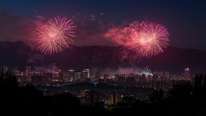 Naklejka premium Fireworks exploding over a cityscape at night with mountains in the background during a celebration