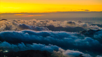 Golden Sunrise Over Mountain Peaks and Sea of Clouds in Scenic