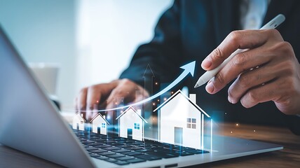 Close up of a person using a laptop with a glowing upward trending graph superimposed over miniature house icons symbolizing real estate growth and investment