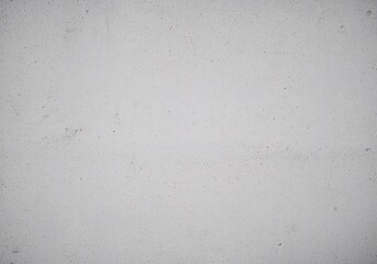 Obraz premium A close-up view of a light gray, grainy paper texture with small, dark flecks and subtle blemishes.