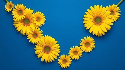 Vibrant yellow gerbera daisies arranged in geometric pattern against deep blue background.