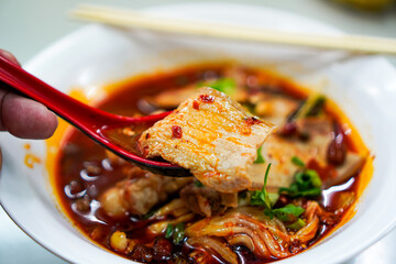 Close-Up of Mala Pork Belly on Chopsticks