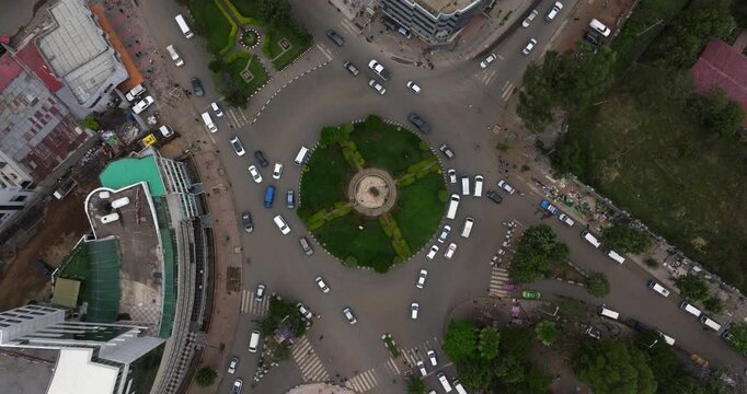 Cars Driving In The Roundabout Surrounded By High-rise Buildings In Addis Ababa City, Ethiopia. - aerial shot