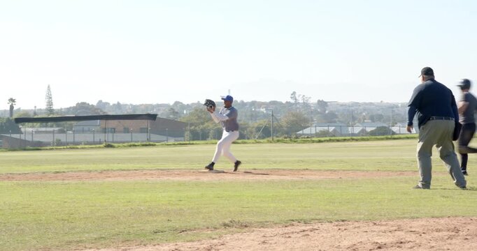 Pitcher on mound pitching sparking 2nd baseman fielding throwing out runner with teammates cheering