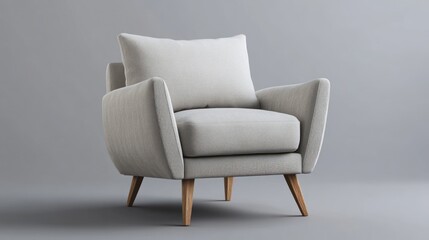 A comfortable looking light gray armchair with a pillow on a gray background in a studio setting view