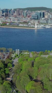 Aerial view of Montreal, Canada, featuring Parc Jean-Drapeau, the Saint Lawrence River, and the Montreal skyline. The park offers recreation and green space.