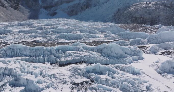 Aerial view of Everest Base Camp glaciers with shining white snow, sunny skies, Khumbu icefalls, and stunning Himalayan mountain scenery with dense snow covered lands at Himalayas Nepal Tourism