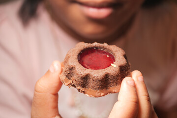 Child enjoys a chocolate dessert with jelly at home