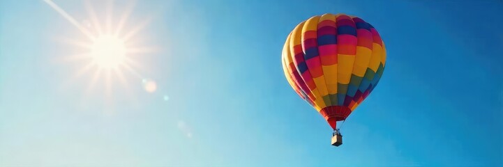 Obraz premium Vibrant Hot Air Balloon Soaring Effortlessly in a Clear Blue Sky Untethered Freedom and Majestic Sunrise