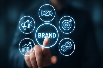 Brand management concept. Businessman touching BRAND icon on virtual screen for Strategic planning, positioning and building