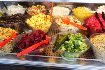 Fresh salad bar with colorful vegetable options in a market