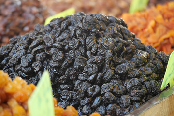 Dried plums at a vibrant market display in summer