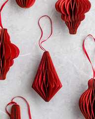 Red Christmas paper baubles as flashlight, Top view pattern on marble grey background, Golden Shiny...