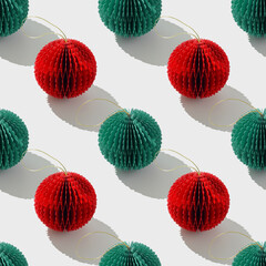 Seamless Minimal pattern of red green paper Christmas ornaments shaped round balls on white,...