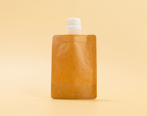 Cream sachet packaging for mockup on a beige background.
