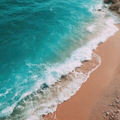 Turquoise waves on a sandy beach