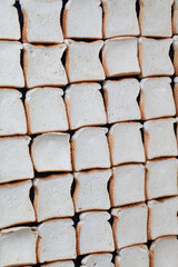 uncooked slices of bread in a row creating a checkered pattern