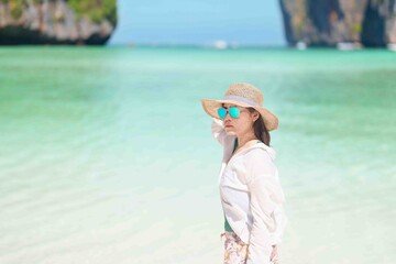 Woman tourist traveling and sightseeing in Krabi, Thailand, happy traveller enjoy at Maya Bay beach...