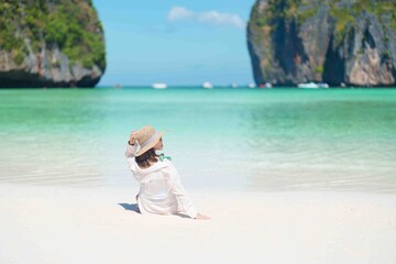 Woman tourist traveling and sightseeing in Krabi, Thailand, happy traveller enjoy at Maya Bay beach...