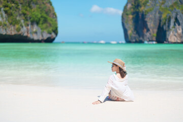 Woman tourist traveling and sightseeing in Krabi, Thailand, happy traveller enjoy at Maya Bay beach...