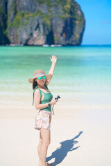 Woman tourist traveling and sightseeing in Krabi, Thailand, happy traveller enjoy at Maya Bay beach...