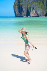 Woman tourist traveling and sightseeing in Krabi, Thailand, happy traveller enjoy at Maya Bay beach...