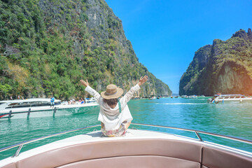 Woman tourist on boat trip, happy traveller relaxing at Pileh lagoon on Phi Phi island, Krabi,...