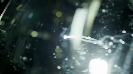 Motion blur of indistinct light trails in a dark, abstract composition