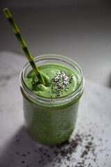 Nutrient-Rich Green Smoothie in a Glass Jar with a Stylish Straw
