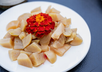 Colorful plate of assorted pickled vegetables arranged with a flower.