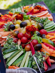 Vibrant Array of Fresh Vegetables on a Rustic Wooden Tray