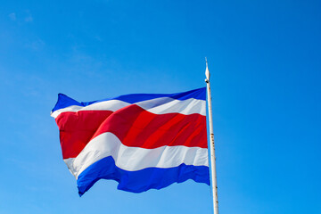 Costa Rica National Flag waving on a clear blue sky
