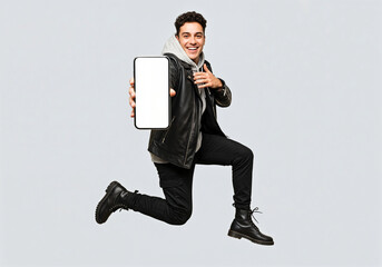 Handsome young man jumping in the air holding a phone