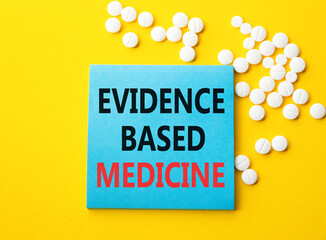 Evidence Based Medicine symbol. Concept word Evidence Based Medicine on blue note. Beautiful yellow...
