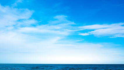 Fototapeta premium Nature of the ocean and blue sky Summer with sunshine, sandy beaches, clear blue waters sparkling against the blue sky. on an island with good ecology and environment Background for summer vacation 